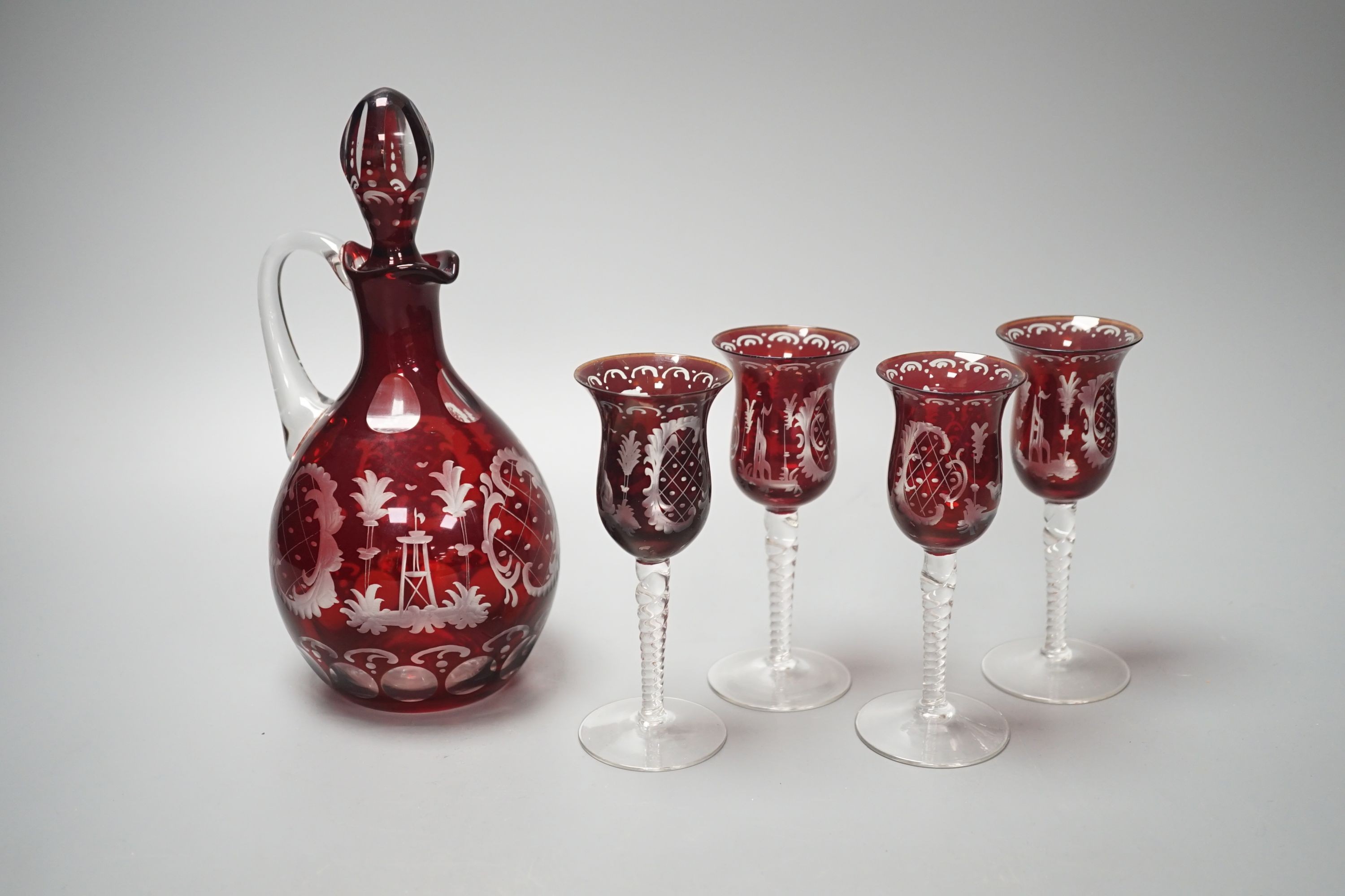 A Bohemian wheel engraved ruby flashed glass decanter and four matching liqueur glasses